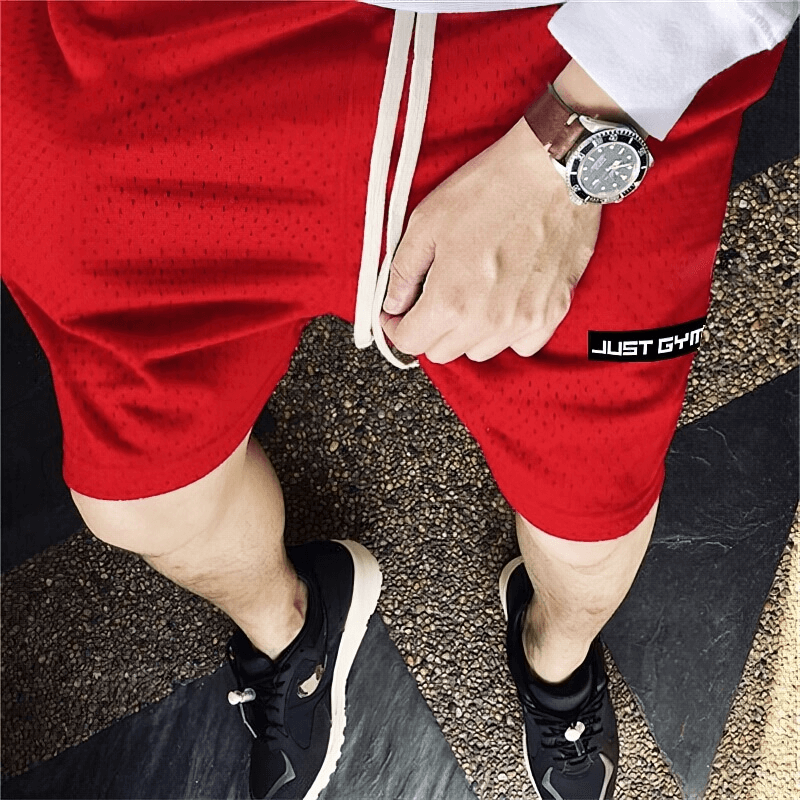 Men's sports mesh running shorts with pockets in vibrant red. Comfortable fit for workouts, featuring breathable fabric and stylish design.